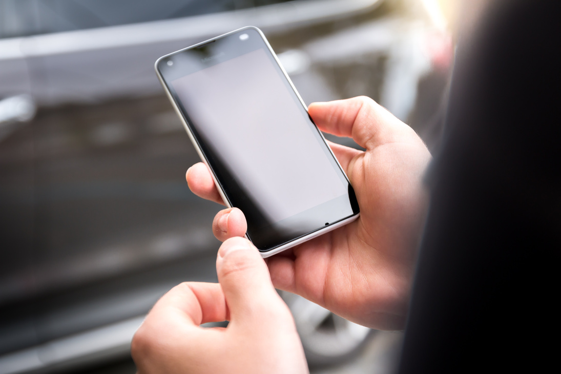 Hands Holding Smartphone Outdoors